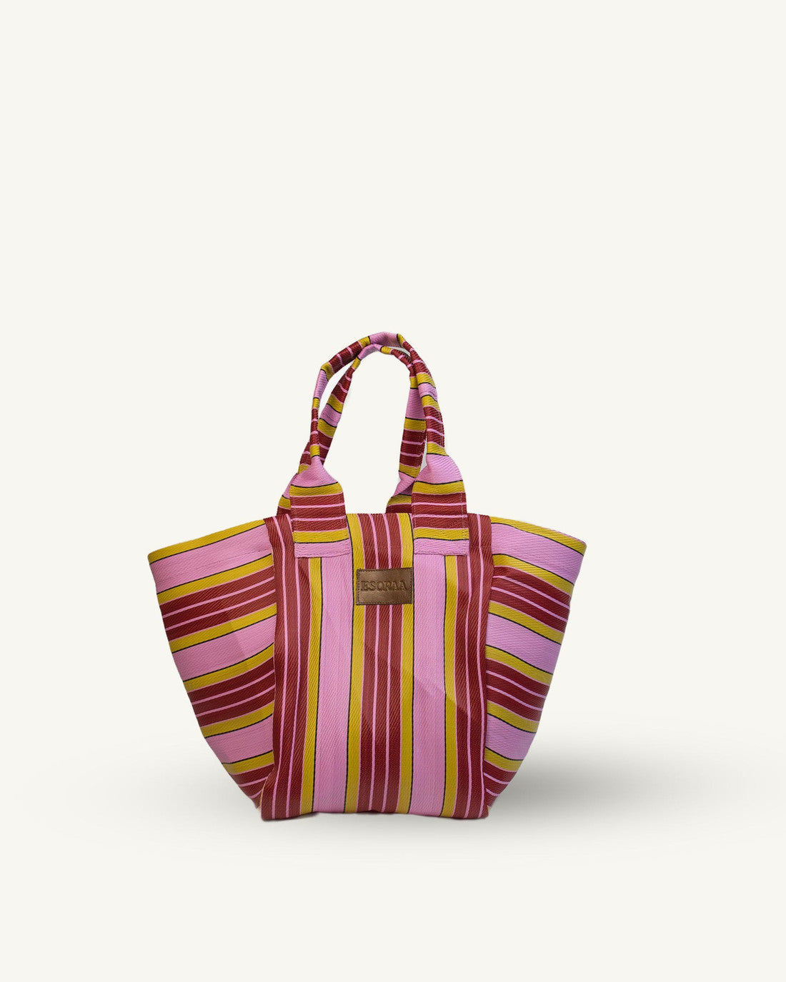 Striped tote bag with pink and yellow pattern on a white background