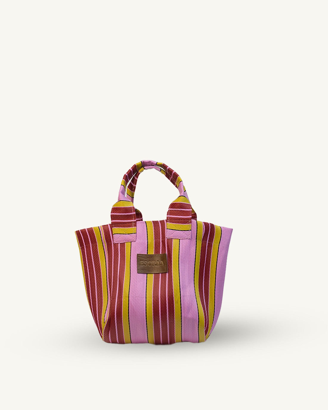 Pink Striped handbag with a brown label on a white background