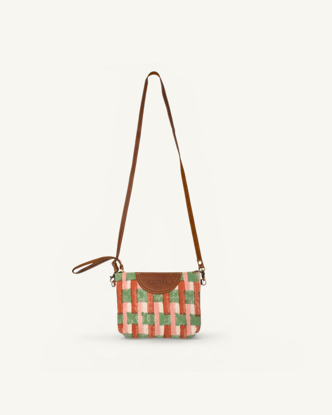 Front view of Esoraa Grid Bruschetta bag in orange hand-block printed organic cotton with the long shoulder strap attached.