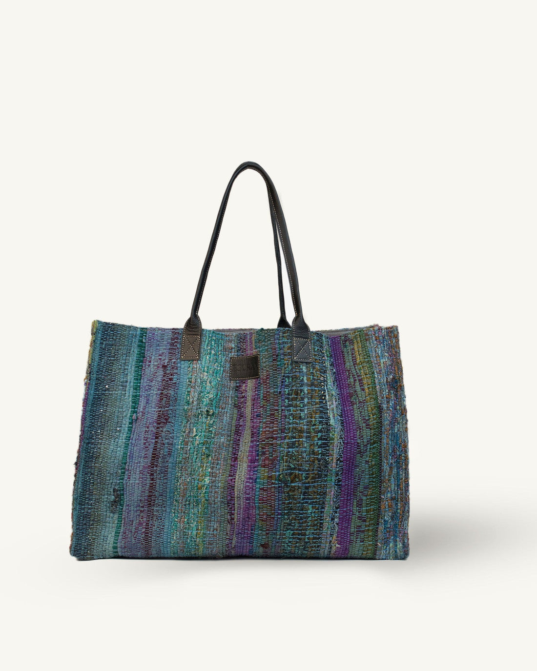 Multicolored blue striped tote bag on a white background