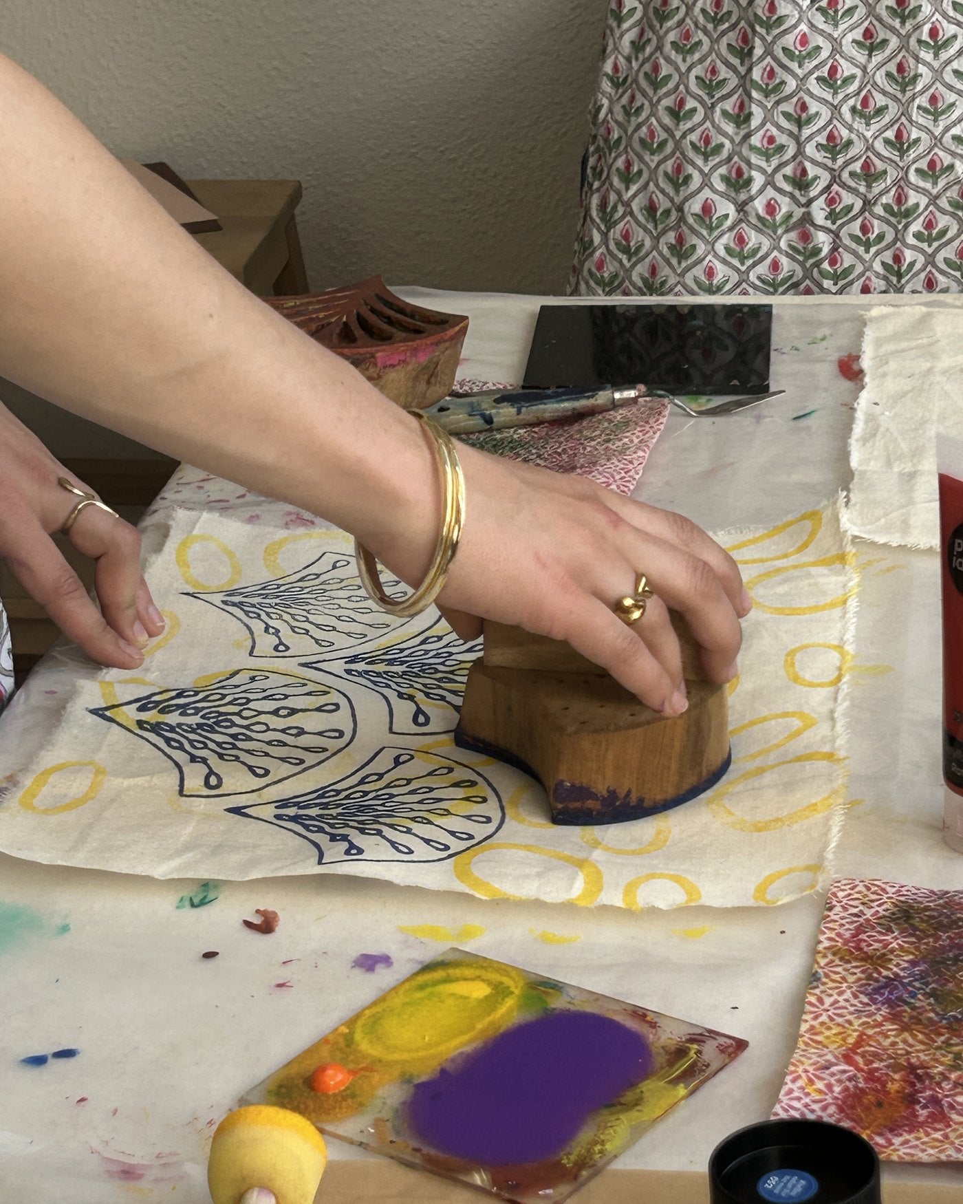 Pressing a wooden block onto patterned cloth