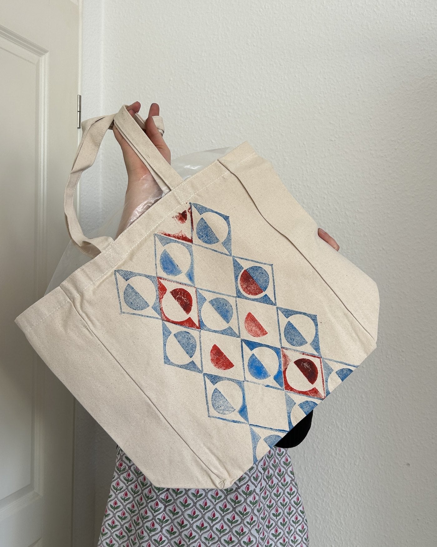 A tote with blue and red diamond prints