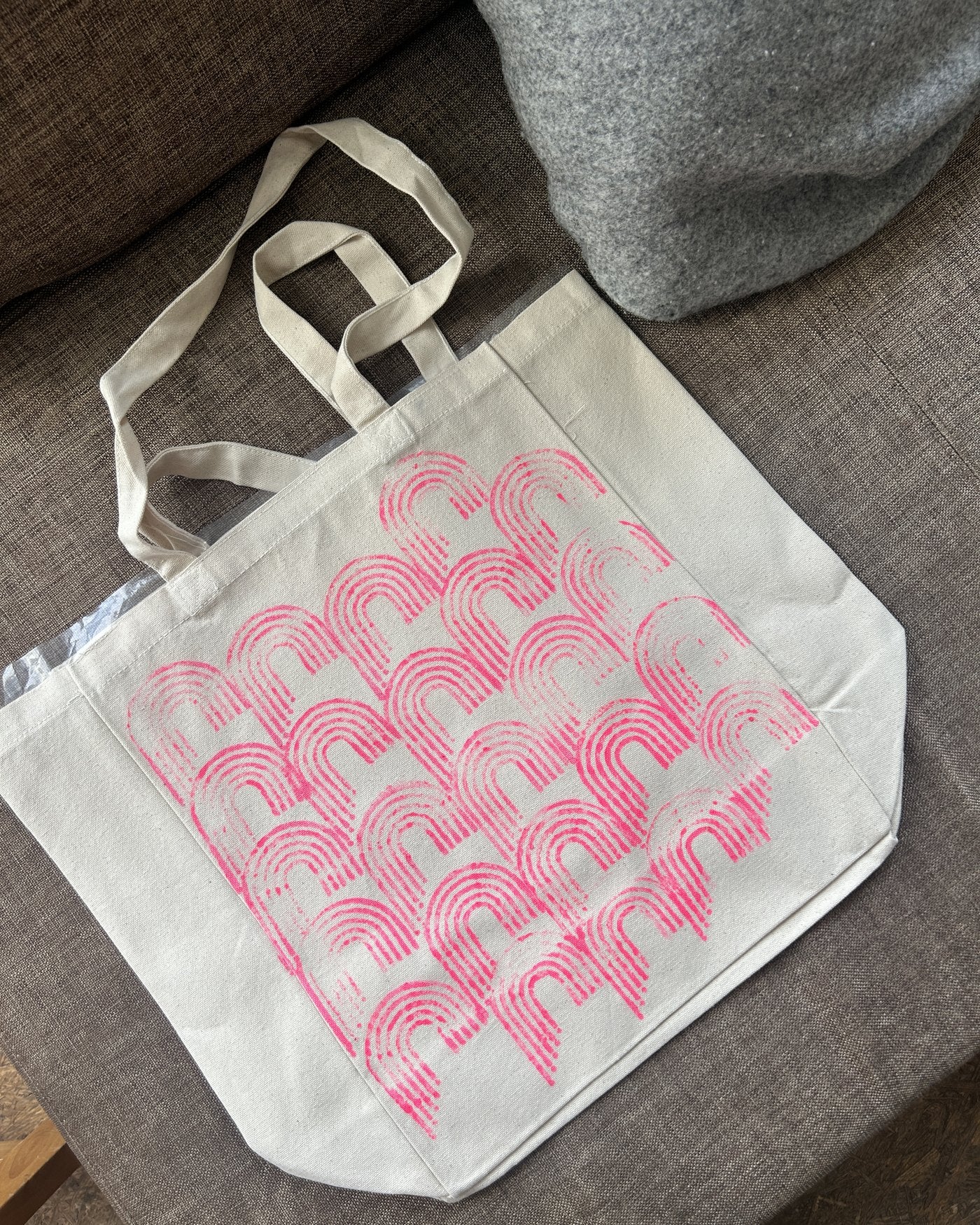 A printed tote resting on a chair
