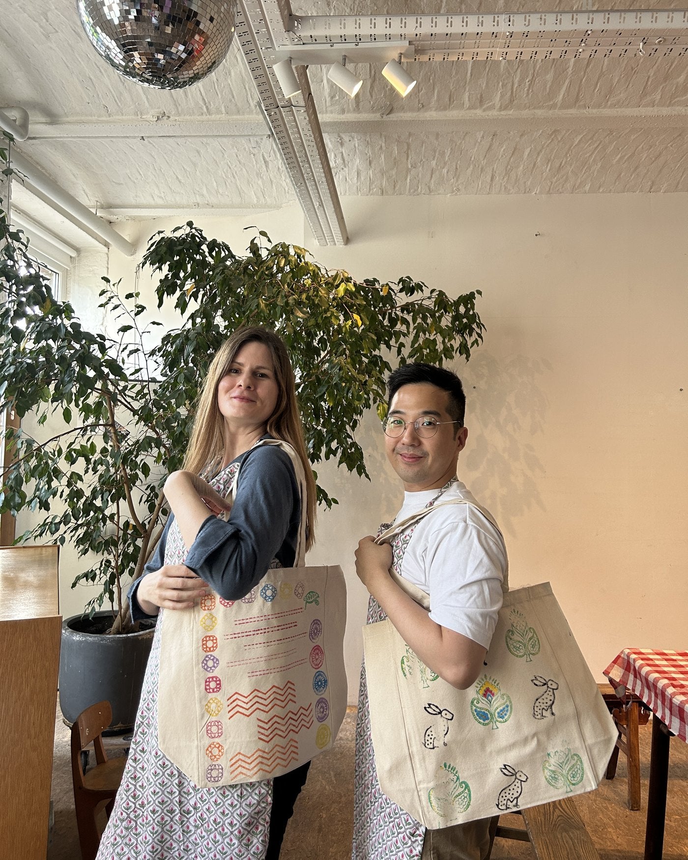 Two colleagues with their finished totes