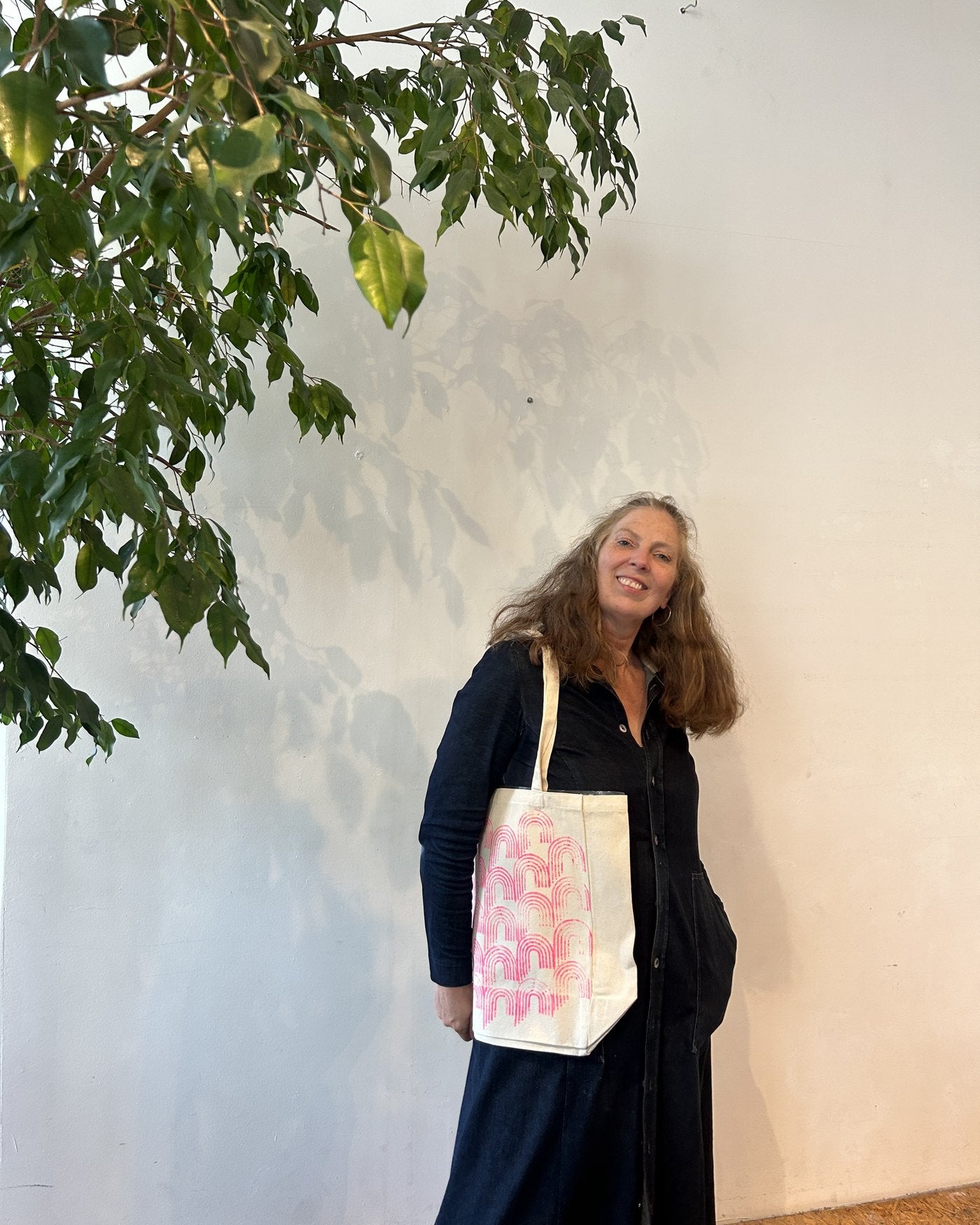 A participant wearing her finished tote