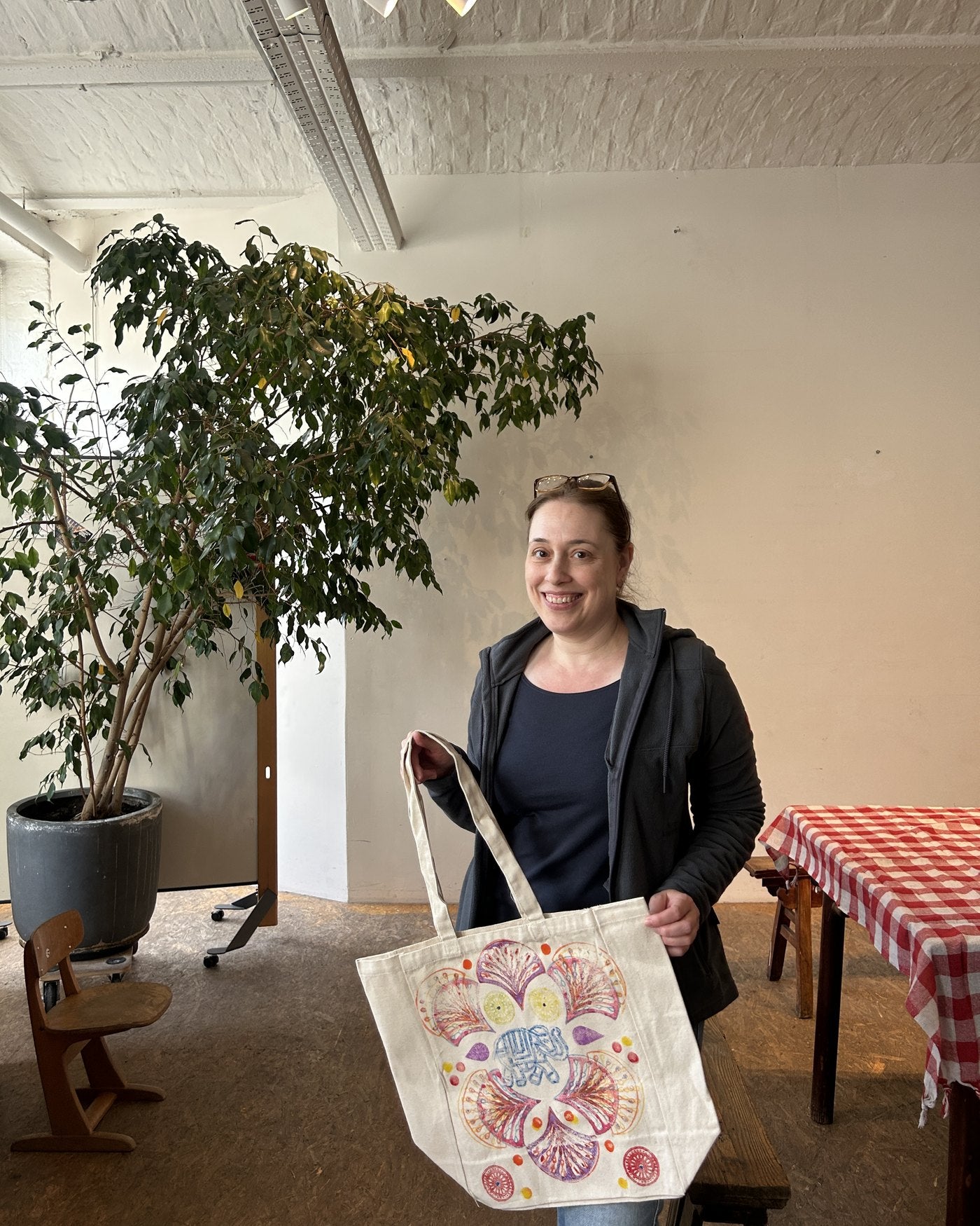 A participant showing her finished tote