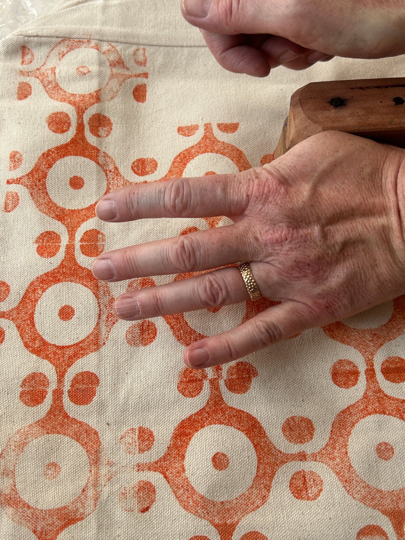 Hand pressing a block onto fabric