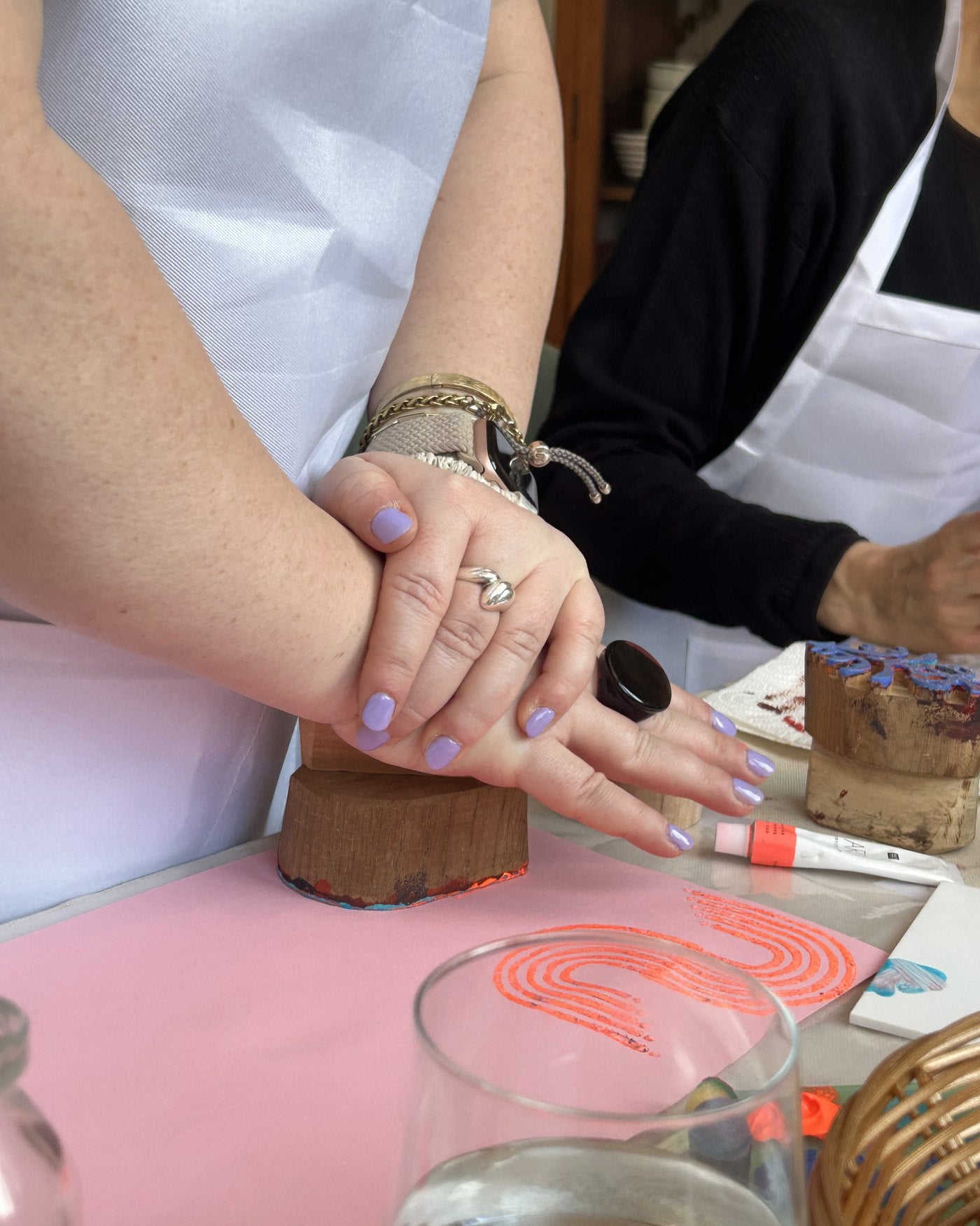 Pressing a block onto pink paper