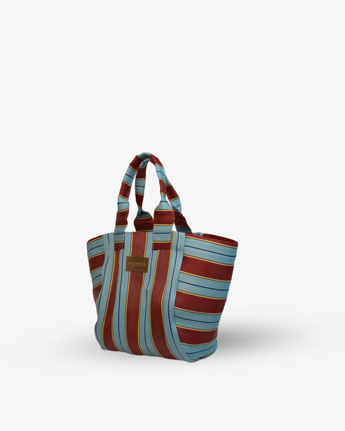 Striped tote bag with brown and blue pattern on a white background