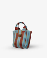 Striped handbag with blue and red stripes on a white background