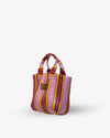 Striped handbag with pink and yellow pattern on a white background
