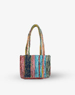 Multicolored striped handbag on a white background