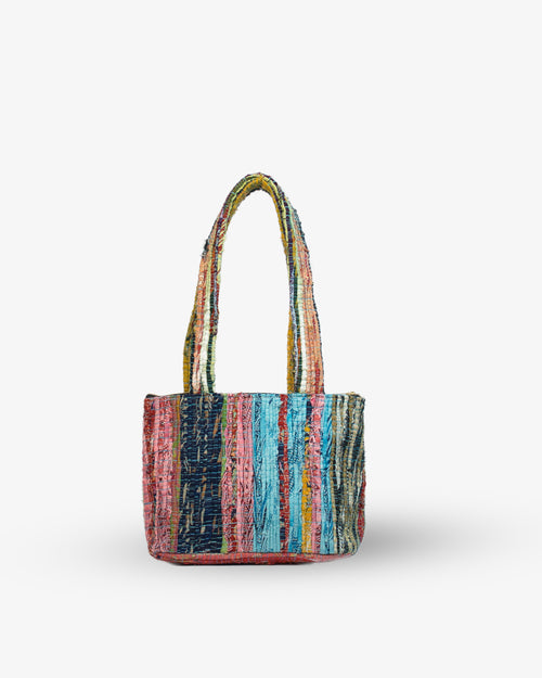 Multicolored striped handbag on a white background