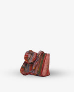 Multicolored woven bag on a white background
