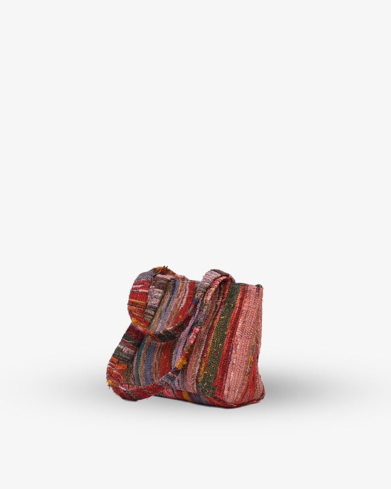 Multicolored woven bag on a white background