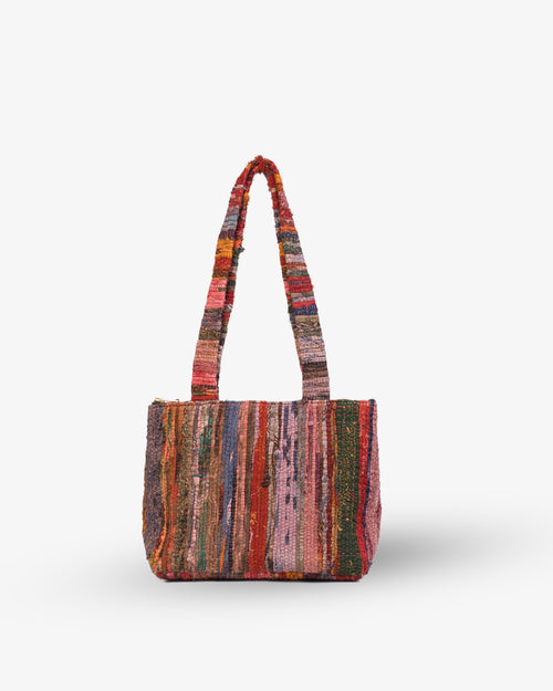 Multicolored striped handbag on a white background