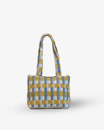 Checkered handbag with yellow and blue pattern on a white background