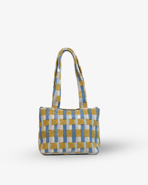 Checkered handbag with yellow and blue pattern on a white background