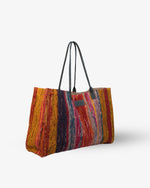 Multicolored red striped tote bag on a white background