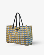 Checkered tote bag with black handles on a white background